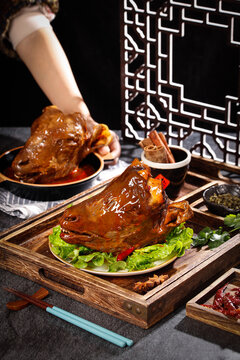 Traditional Chinese Roasted Duck with Marinated Glaze and Lettuce Garnish on Wooden Serving Tray