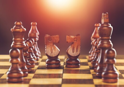 Wooden chess figures on a classic chessboard