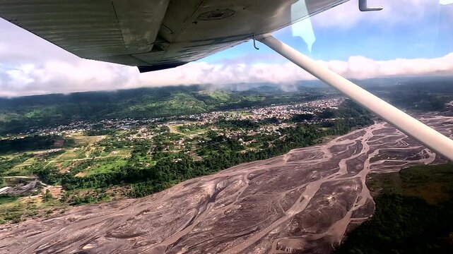 Aerial View of Braided River Valley and Tropical Landscape from Small Airplane Window, Ecuador Rainforest, Remote Aviation Travel and Wilderness Exploration Scene