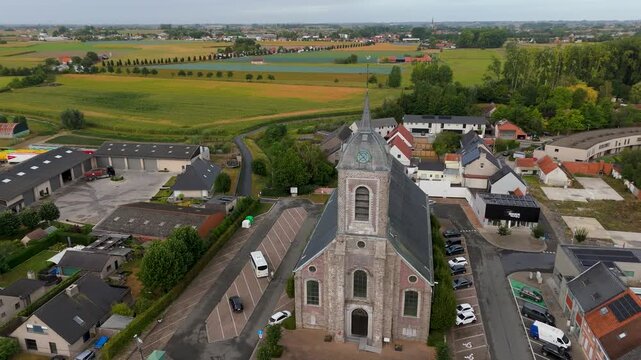 Scenic drone shot capturing the Saint Peter church and surrounding town landscape of Ledegem in West Flanders, Belgium.