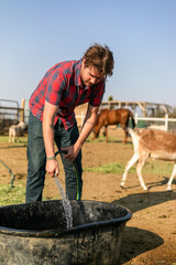 Man watering animals outdoors farm © Rawpixel.com