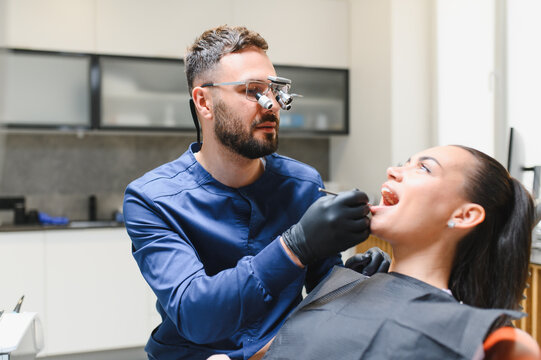 Dentist examining patient's teeth during dental checkup