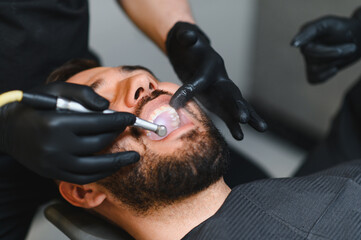 Fototapeta premium Man receiving professional dental care in clinic