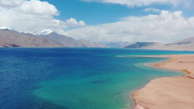 Drone Aerial Orbit shot reveal of Pangong Lake Ladakh and snow capped Himalayas.. High Altitude Lake in Greater Himalayas