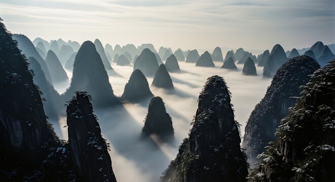 Beautiful mist and fog surrounding green karst mountain peaks.