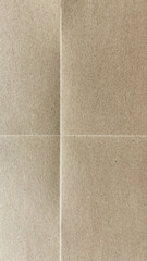 Fototapeta premium Close-up of a textured, folded brown paper surface with visible creases.