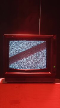 Retro TV, vintage television In a nostalgic setup, a retro TV displays grain on screen, scary halloween night device good for chroma key and green screen