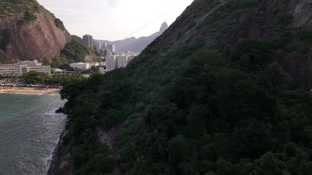 Aerial view of Praia Vermelha beach nestled between lush green mountains and the Atlantic Ocean in Rio de Janeiro, State of Rio de Janeiro, Brazil.