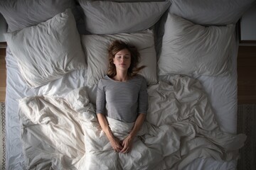 Obraz premium Overhead view of a woman in four sleep positions on a bed