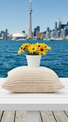 Obraz premium Potted yellow flowers resting on cushion by waterfront