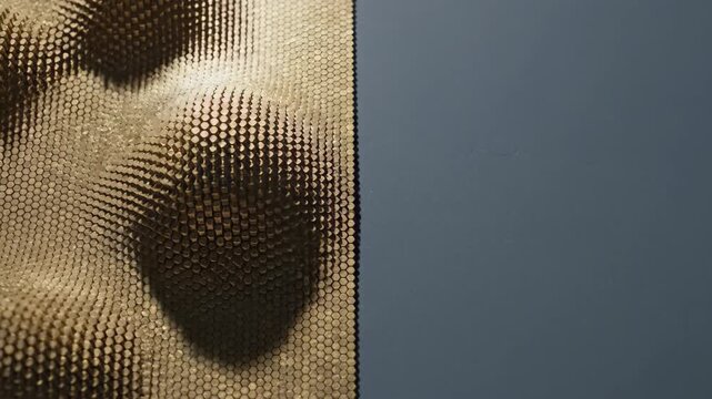 Kinetic sculpture made of moving metal pins changing shape. Abstract mechanical surface with wave pattern. Industrial design prototype for modern technology display