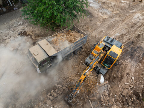 Aerial View of Construction Site with Excavator and Dump Truck