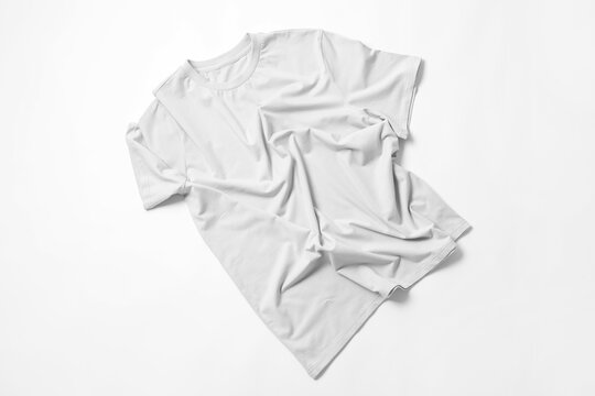 Crumpled light grey t-shirt on white background, top view. Mockup for design