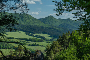 Obraz premium Green fresh spring landscape blue sky hot day Strazovske mountains and Sulov