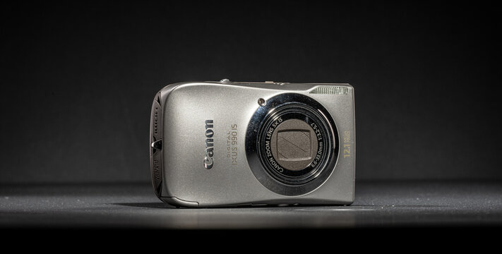 Gothenburg, Sweden - October 08 2023: Silver Canon IXUS compact digital camera on dark background.
