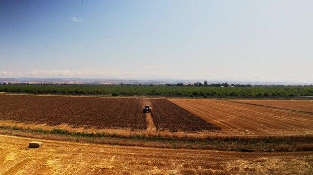 Drone aerial view of farmstead and acres of farmland in Chico, California 