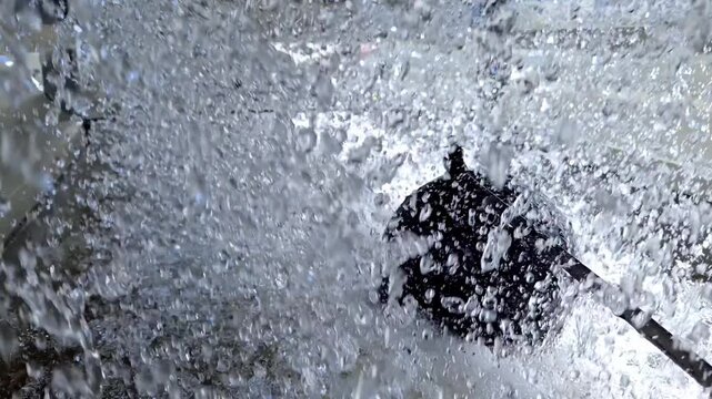 Close Up of Water Splashing and Spraying Inside Industrial Cooling Tower