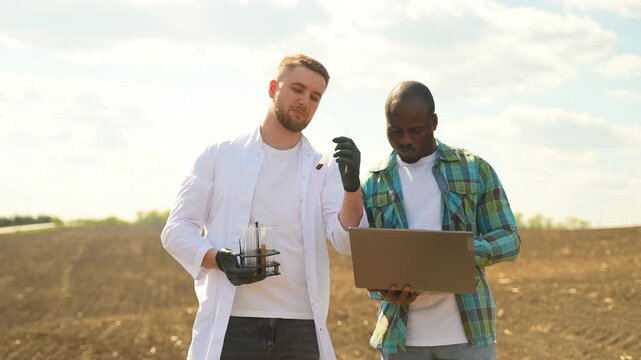 Scientist and farmer analyzing soil samples in the field