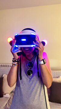 Woman playing with virtual reality headset and controllers