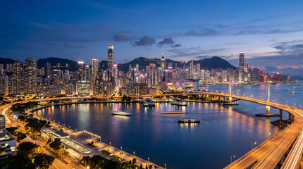Naklejka premium Wide angle landscape showcasing modern corporate architecture and majestic twilight sky over bustling international metropolis