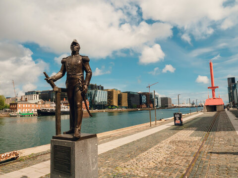 Dublin, Ireland - 03.05.2026: Admiral Brown Statue, Diving bell and modern buildings in the background. Warm sunny day with cloudy sky. City landmark.