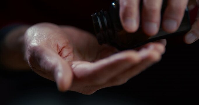 Open human hand palm up in dark low key lighting with isolated background