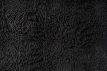 Dark black faux fur texture with soft vertical fibers and elegant plush surface, premium luxury background for Black Friday sale banners, fashion branding and cosmetic product display © svittlana