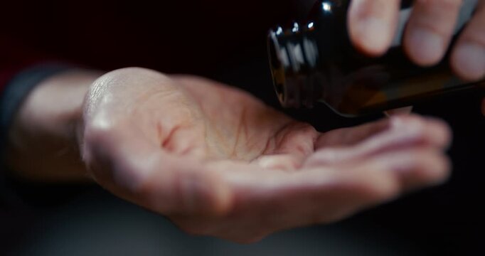 Open human hand with palm up in soft light against dark blurred background