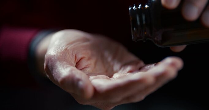 Open human palm isolated against dark background with soft dramatic light