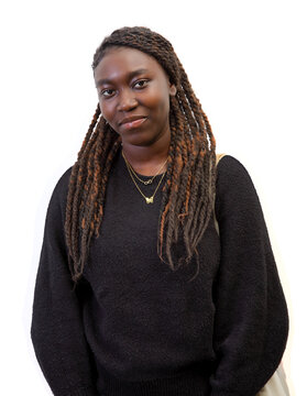 Half-length cutout portrait of a casual young Black woman with long braids isolated on a white background