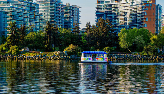 Aquabus Ferry on False Creek with Olympic Village Skyline in Vancouver, British Columbia