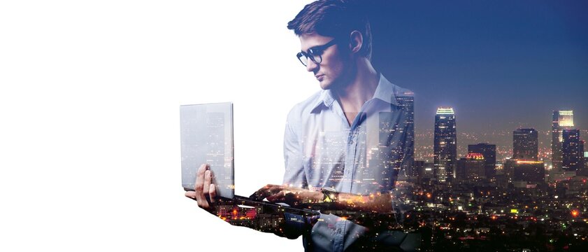 A young business man in eyeglass with laptop computer