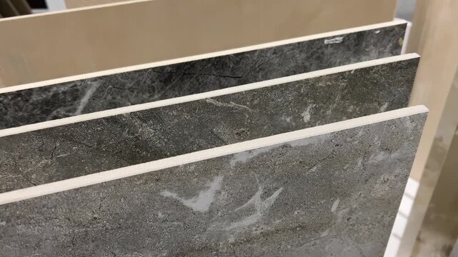 Large Format Ceramic Tiles on Display in Home Improvement Store | Close-Up of Dark Gray Stone Texture Marble Pattern Porcelain Slabs | Interior Design Materials