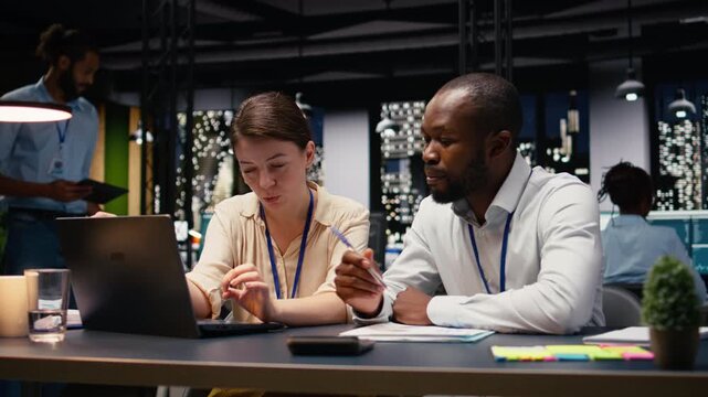 Diverse group of business professionals working together in workspace, collaborating on project assignments. Staff developing strategic agenda to drive company growth and success.