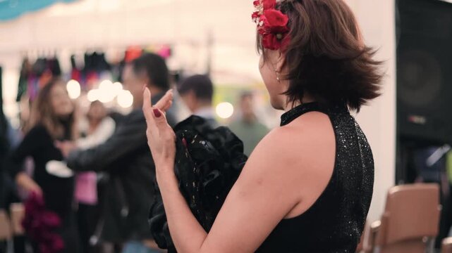 Beautiful mature woman, made up and formally dressed, applauding a cueca brava dance. Dance event. Typical Chilean dance, national dance of the national holidays.