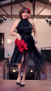 Beautiful mature woman, made up and formally dressed, delicately dancing the cueca brava. Dance event. Traditional Chilean dance, national dance of the national holidays.