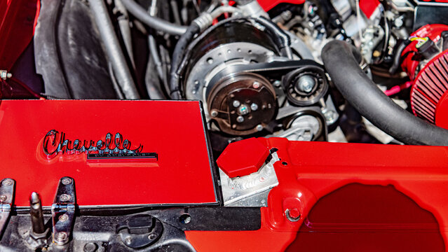 closeup chevrolet chevelle emblem on restored red classic muscle car engine compartment