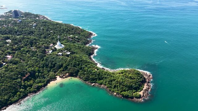 Aerial view of Japanese Peace Pagoda Rumassala on a lush green hill overlooking the turquoise Indian Ocean Unawatuna, Southern Province, Sri Lanka.