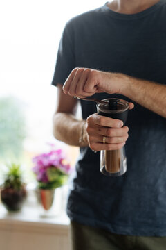 Crop guy grinding coffee
