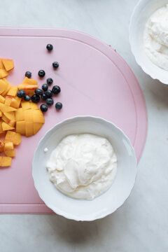 Cut fruit and berries near dairy