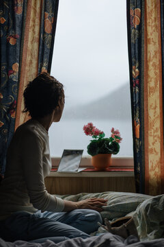 Thoughtful woman looking away in window 