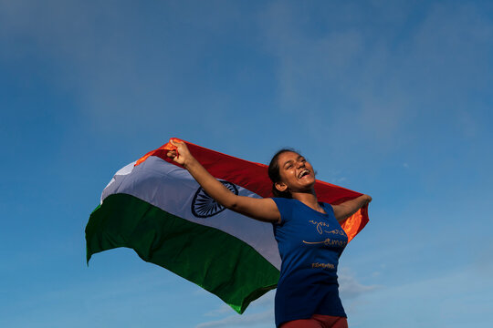 Teenage girl making fun with Indian flag at outdoors