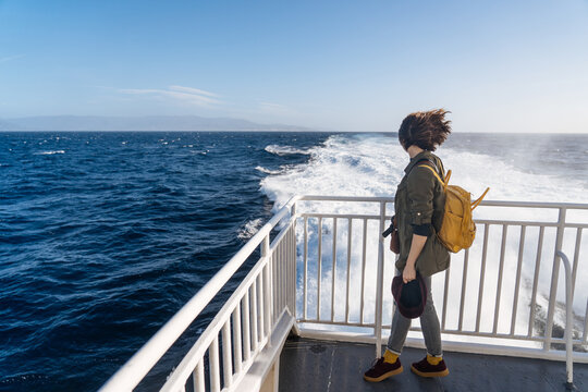 Meditative female standing on deck in wind