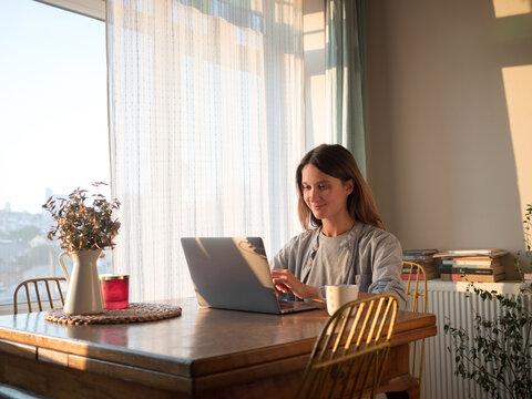 Bright Afternoon at Home With a Woman Working on Her Laptop