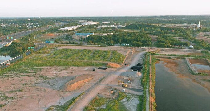 20 September 2025 Sayreville NJ Construction site near highway, river area has land being cleared prepared for new buildings are vehicles and equipment scattered around.