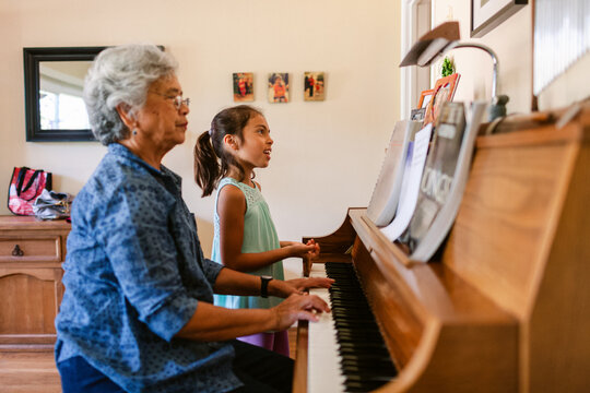 Elderly Woman and Girl Play Piano