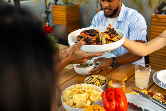 Sharing Food at Backyard Barbecue Gathering