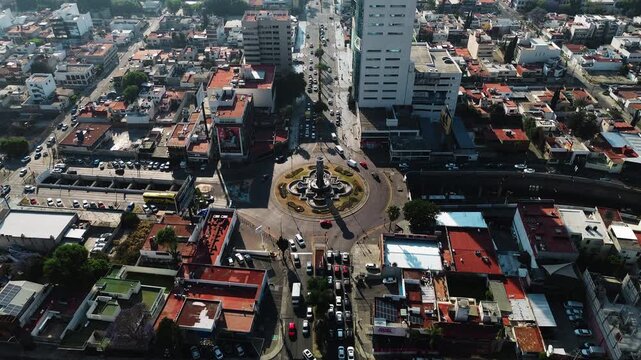 Puebla Fuente de los Frailes Roundabout on Juarez Avenue with Active Vehicle Traffic Flow at Sunrise Vertical Tilt Movement Aerial Drone POV 4K 29fps Editorial Video Asset