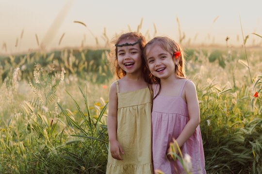 The sisters are standing in a field