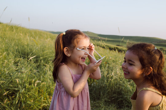 The sisters are standing in a field